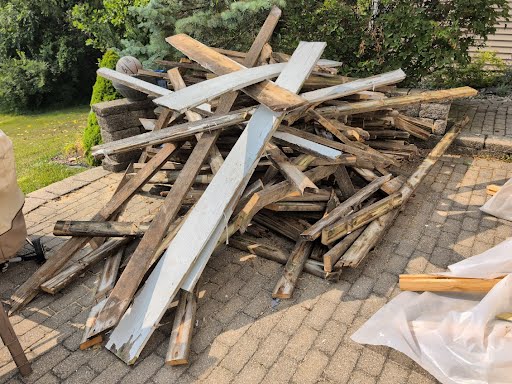 Demolished deck lumber ready for removal by Junkernauts Junk Removal